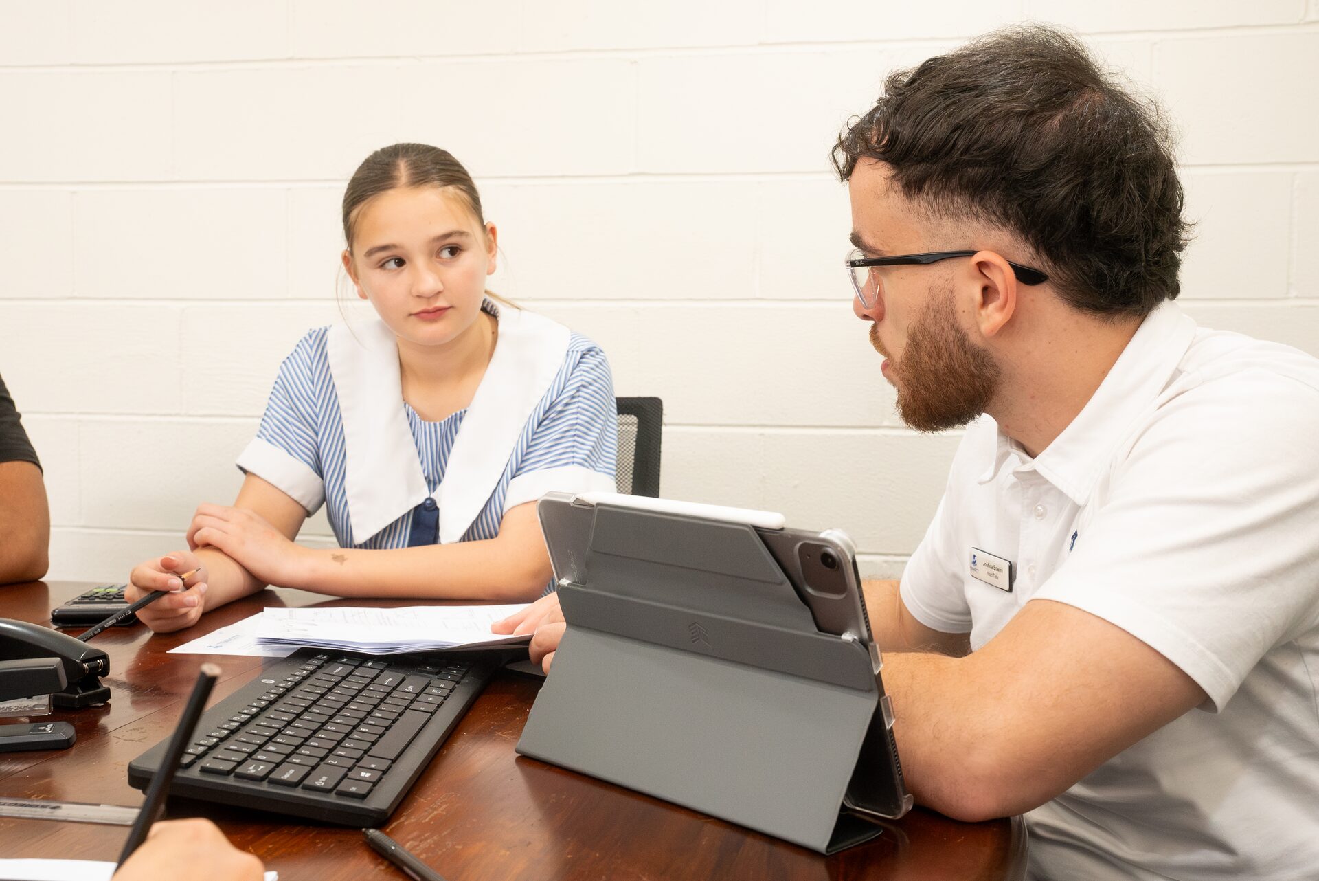 A Tenacity tutor helping a student with maths